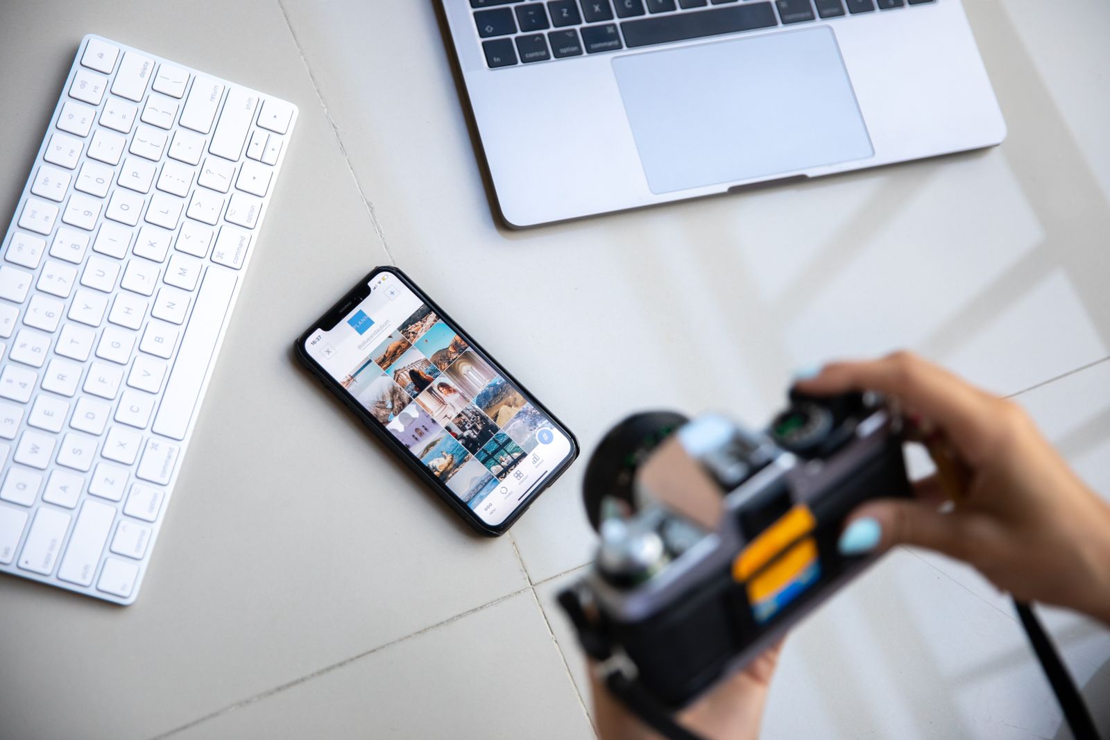 A person photographing equipment on a workbench with a smartphone