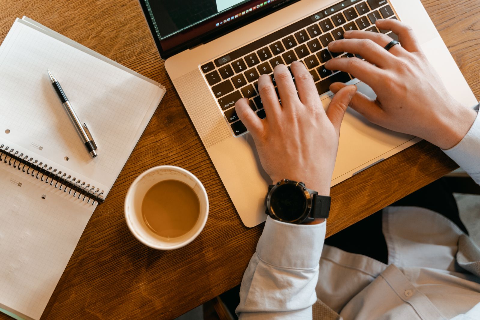 A guest reading a warm, well-written email on a laptop at a kitchen table