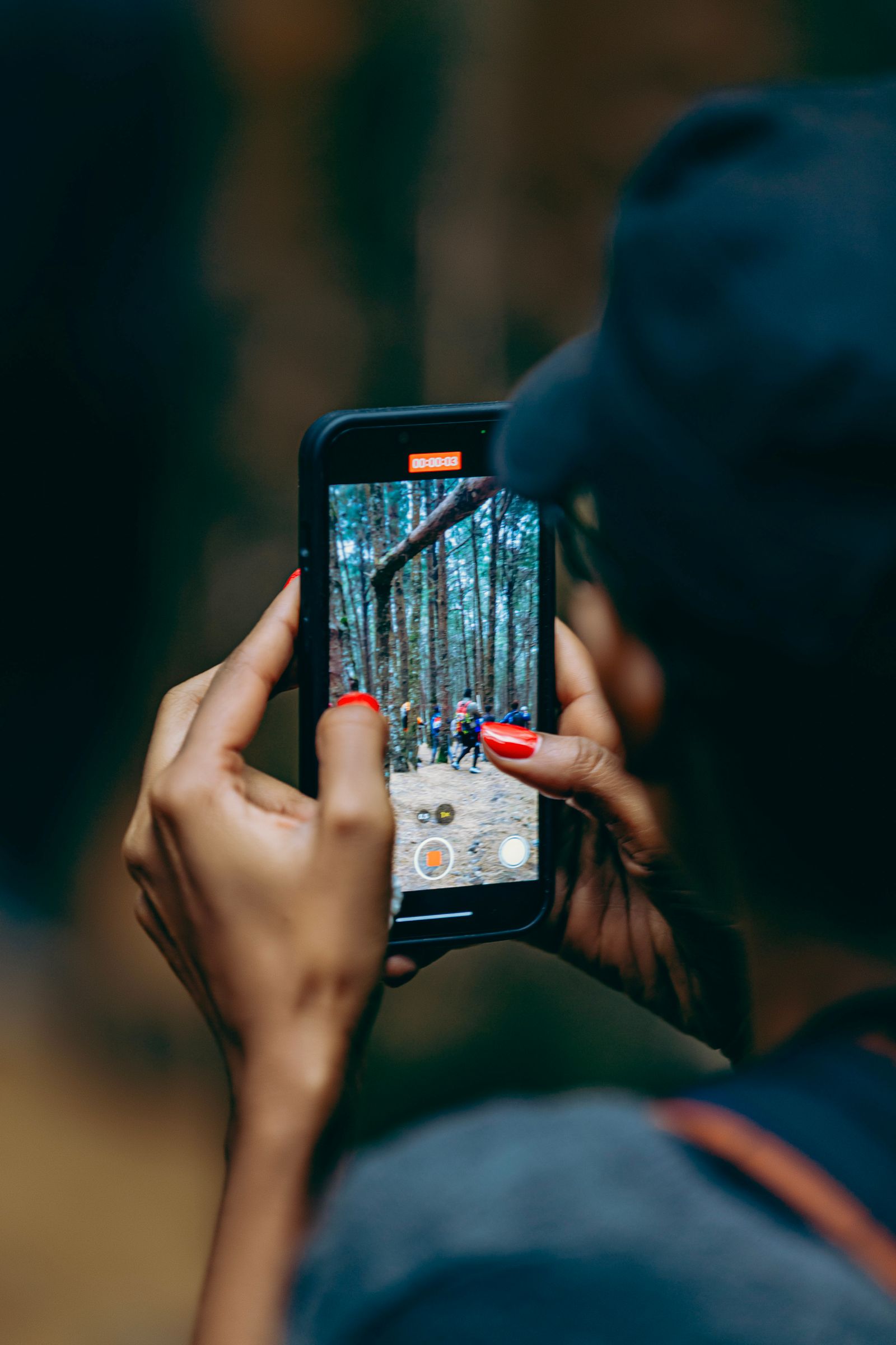 A person checking their phone while out in nature