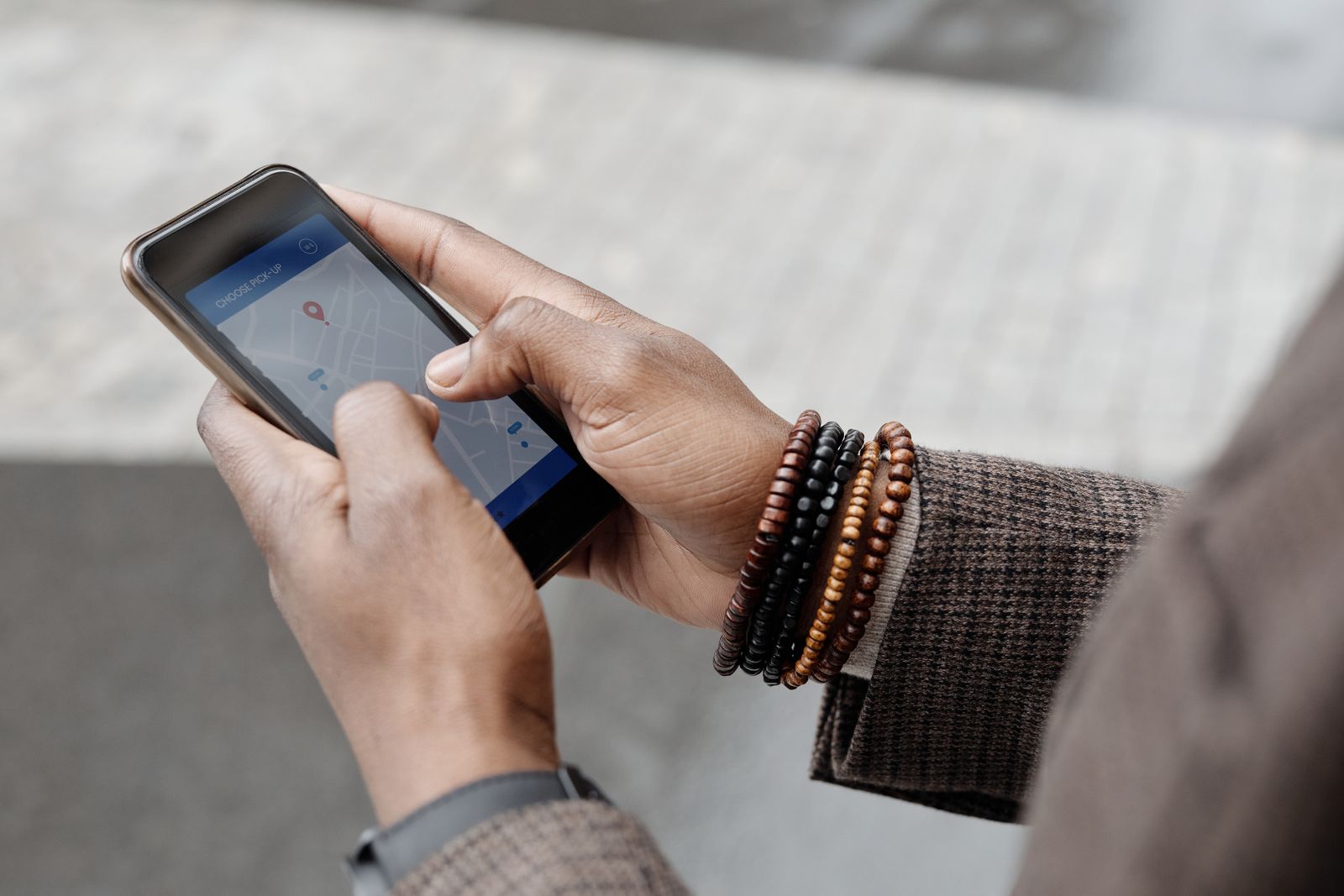 A traveler using a maps app on a smartphone outdoors