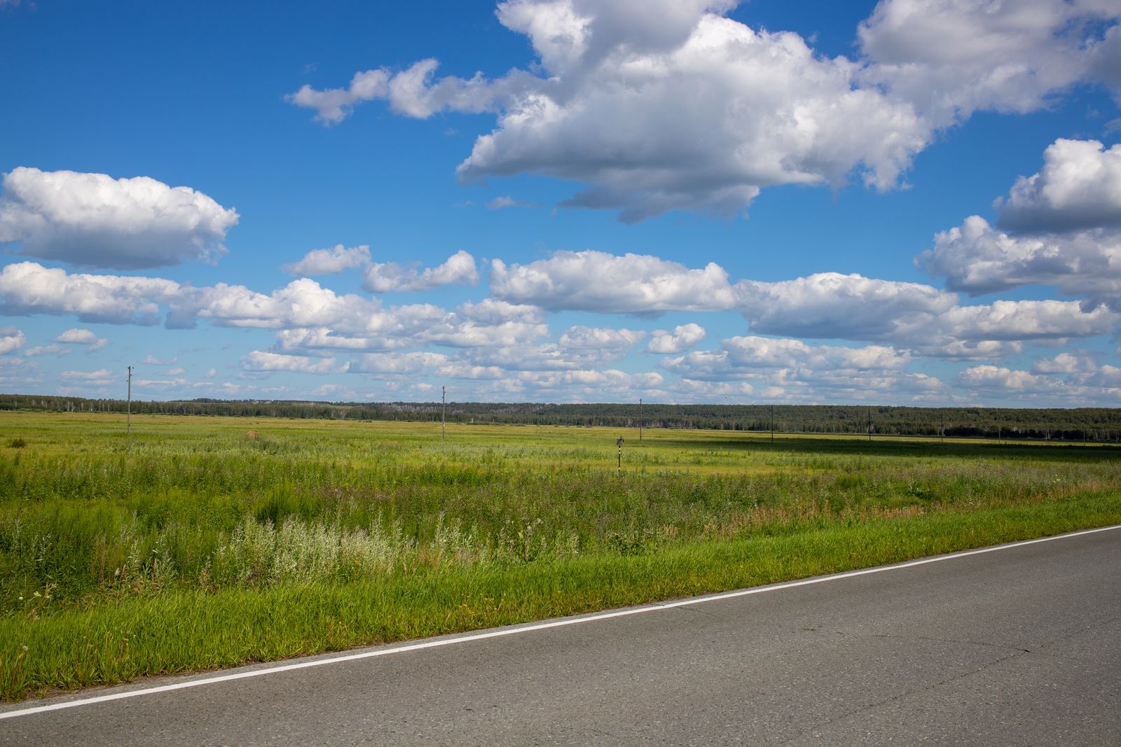 A quiet rural road winding through open countryside